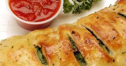 Pizza Calzone with ham and herbs